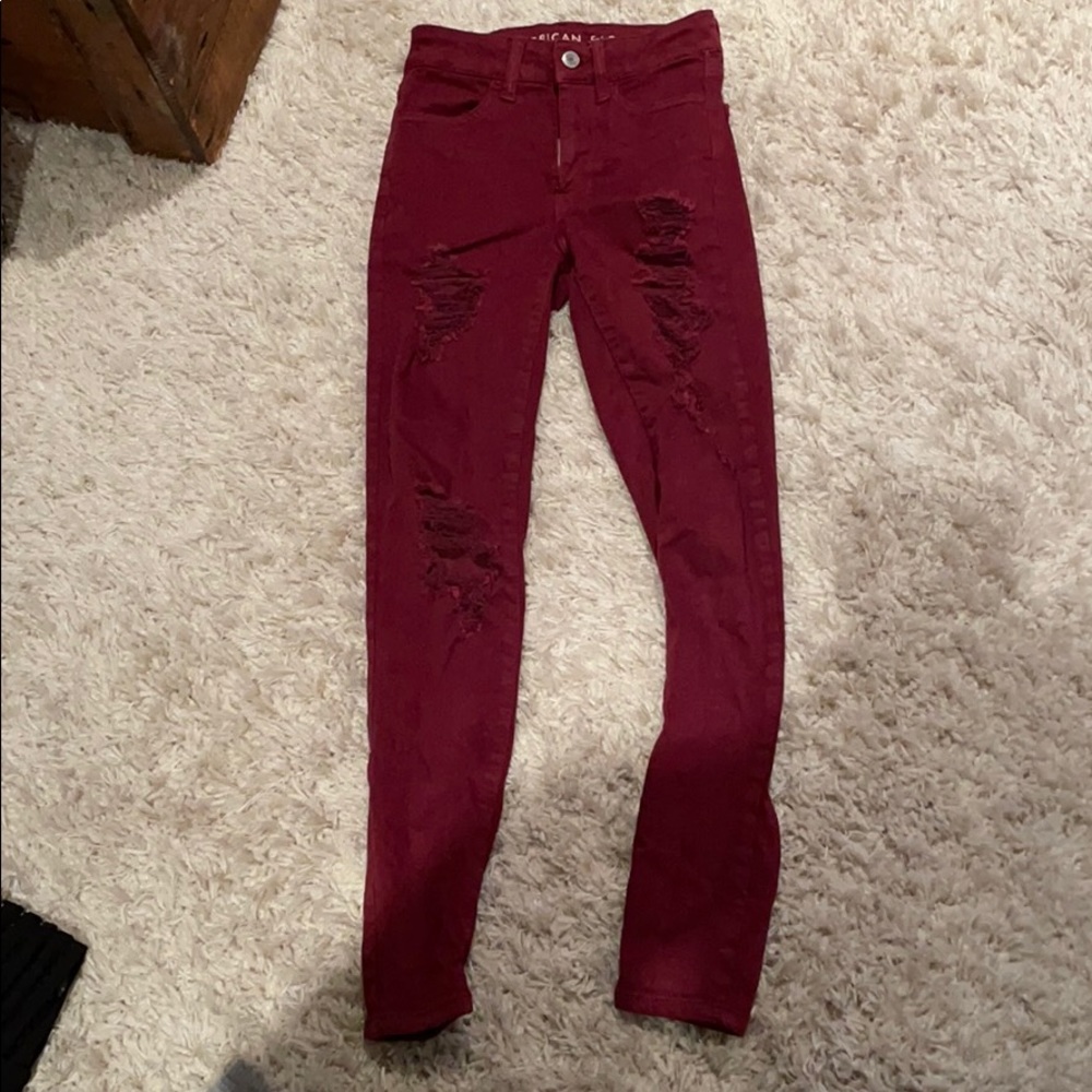 Distressed maroon jeans
